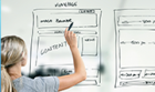 Woman writing out wireframe for a webpage design
