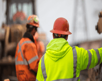 Construction worker surveying a site