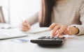 Woman working out costs on a calculator