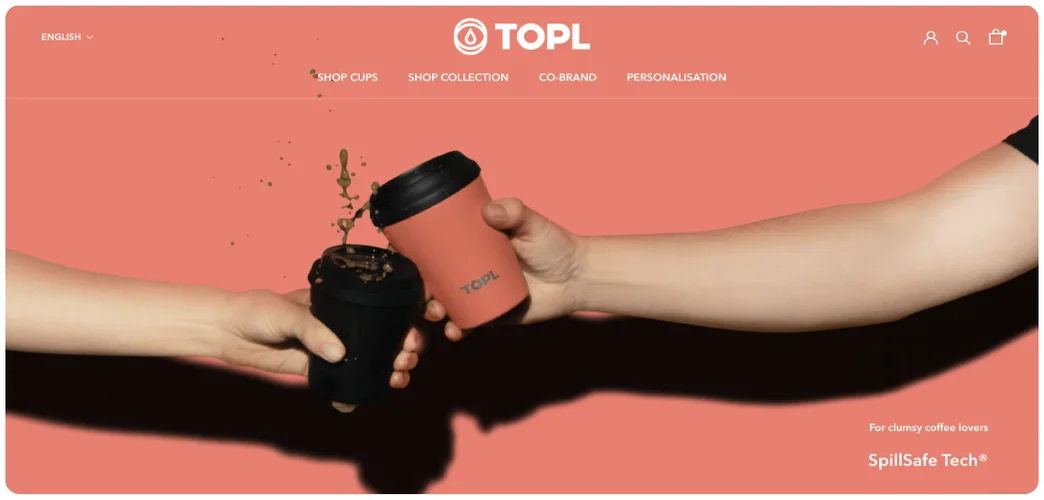 Screengrab of website landing page coral background with two coffee cups spilling coffee