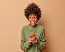 social media managing companies leader happily holding smartphone