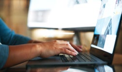 cropped shot of web designer on laptop