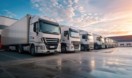 trucks in a row with sunrise sky line in the background