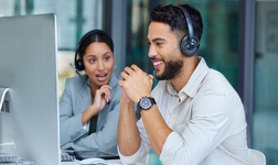 people talking at a desk using the best free CRM software to speak to customers