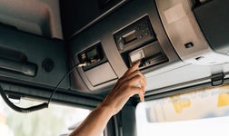 Tachograph in lorry being pressed by the driver