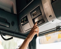 Tachograph in lorry being pressed by the driver