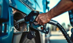 A person fills up their truck with fuel.