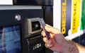 Person paying with fuel card at petrol pump for diesel gas