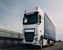 Lorry moving down a motorway at speed, front angled upwards from below