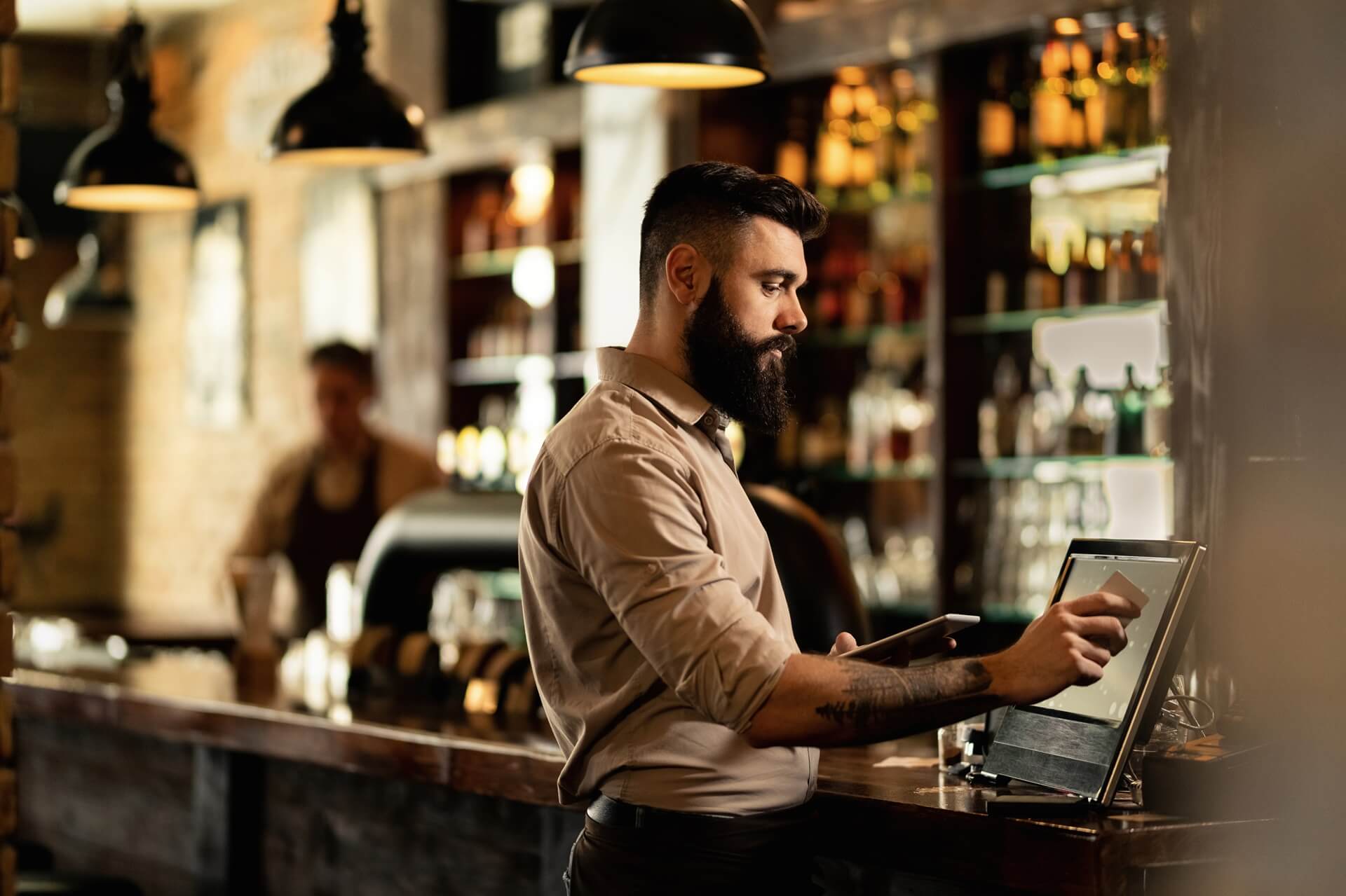Bar tender operating a register/till POS system