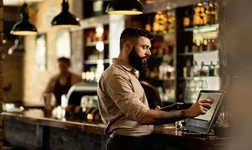 Bar tender operating a register/till POS system
