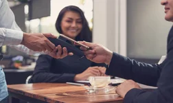 Man paying for meal at restaurant using digital wallet on phone