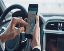 man in car using GPS car tracker