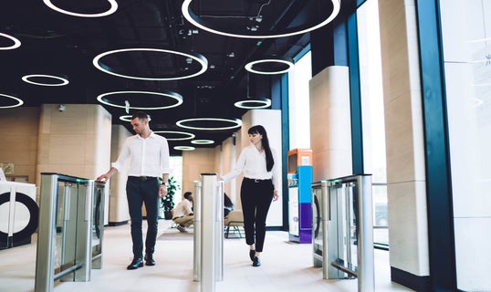 Two coworkers going through checkpoint at workplace