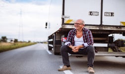 Man sitting at the back of a truck