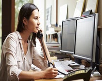 Woman speaking on the phone in a home office