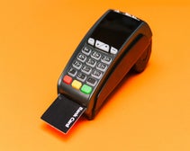 EPOS card reader paying via bank card on orange background