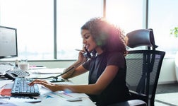Woman making a phone call in an office