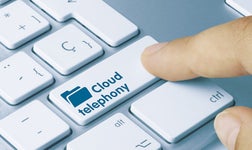Finger pressing button that reads 'Cloud telephony'