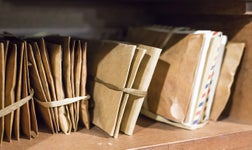 Stack of old letters on a wooden bookcase