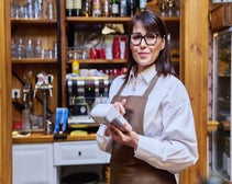 Bar owner using a POS payment terminal