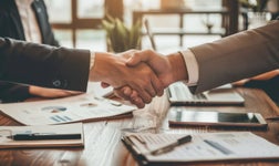 Two people shake hands