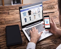 hand typing on laptop screen depicting ecommerce platforms