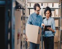 employés entre étagères d'un entrepôt