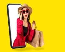 Woman wearing sunglasses holding shopping bags