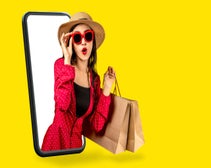 Woman wearing sunglasses holding shopping bags