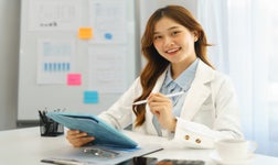 SEO audit cost professional woman holding tablet