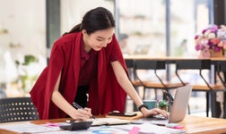 office worker using SEO audit tools on laptop