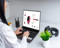 woman using laptop setting upcommerce platform for items like smartwatch