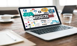 Laptop on desk featuring a website