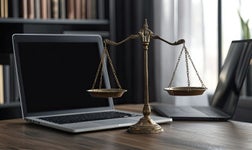 A laptop and weighing scales on a lawyer's desk.