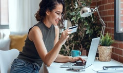 Woman on her laptop with credit card