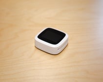 the Revolut card reader pictured on a wooden table.