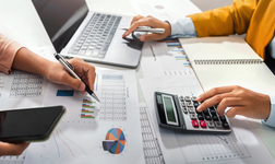 close up hand accountant holding pen pointing on paperwork chart for meeting team in office room