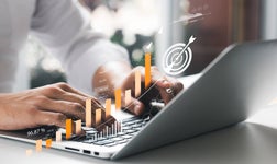 Businessman analyzing company's financial balance sheet working with digital augmented reality graphics. Businessman calculates financial data for long-term investment
