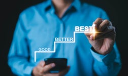 Man in blue shirt drawing stairs labbeled 