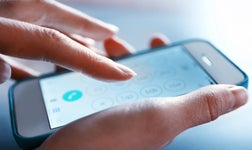 Finger touch number on smartphone to make a call, close up