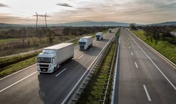 Caravan or convoy of trucks in line on a country highway