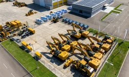 fleet of construction vehicles at a company site