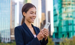 woman in downtown vancouver Canada holding a mobile phone