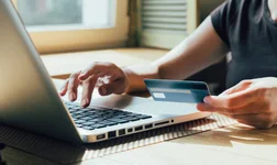 woman makes a purchase on the Internet on the computer with credit card
