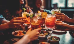 Close up of friends group cheering mojito drinks at bar restaurant. Generative AI.