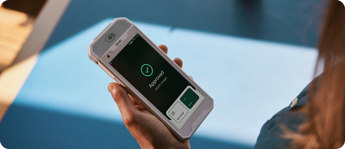 Dojo Pocket card machine in a person's hand